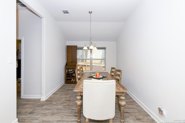 1710 Briar Spg, San Antonio, TX 78245 - dining space with a chandelier, wood finished floors, baseboards, and vaulted ceiling
