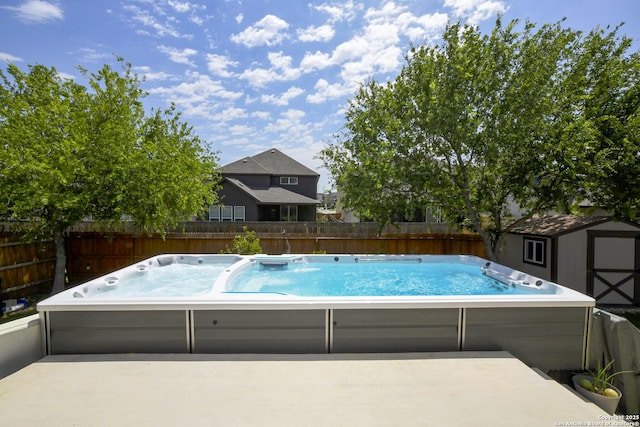 1710 Briar Spg, San Antonio, TX 78245 - view of pool with a hot tub, a shed, a fenced backyard, an outbuilding, and a patio