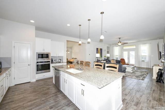 1710 Briar Spg, San Antonio, TX 78245 - kitchen with a sink, stainless steel appliances, open floor plan, wood finished floors, and recessed lighting