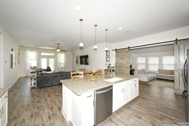 1710 Briar Spg, San Antonio, TX 78245 - kitchen featuring a barn door, a sink, open floor plan, dishwasher, and ceiling fan