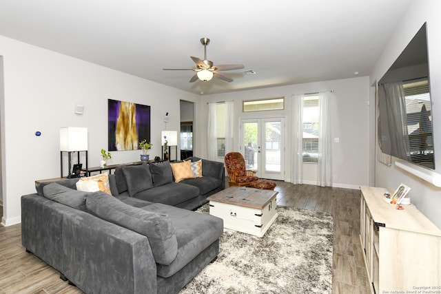 1710 Briar Spg, San Antonio, TX 78245 - living room featuring a ceiling fan, light wood finished floors, and baseboards