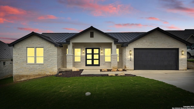 modern farmhouse featuring a standing seam roof, metal roof, and stone siding