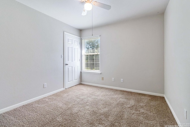 empty room with carpet floors, baseboards, and a ceiling fan