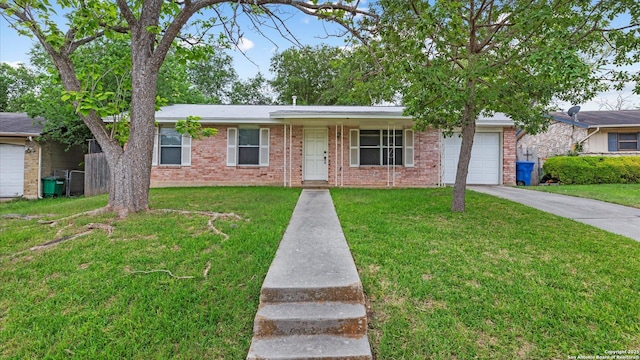 4722 Casa Manana, San Antonio, TX 78233 - ranch-style home with an attached garage, driveway, a front lawn, and brick siding