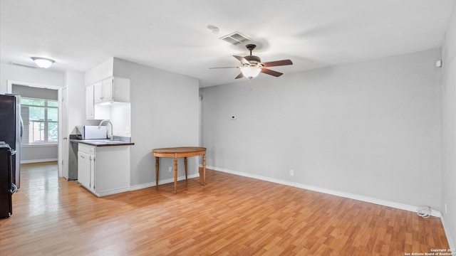 4722 Casa Manana, San Antonio, TX 78233 - unfurnished living room featuring light wood-style flooring, a ceiling fan, baseboards, and a sink