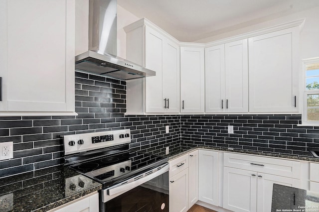 1615 N Guadalupe, Seguin, TX 78155 - kitchen with wall chimney range hood, stainless steel electric range, white cabinetry, and decorative backsplash