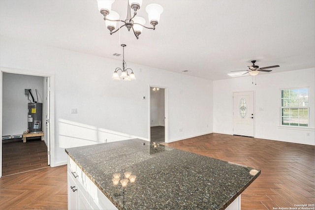 1615 N Guadalupe, Seguin, TX 78155 - kitchen with a chandelier, water heater, ceiling fan, white cabinetry, and open floor plan