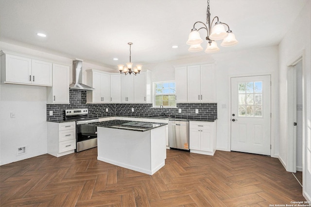 1615 N Guadalupe, Seguin, TX 78155 - kitchen featuring a chandelier, appliances with stainless steel finishes, a sink, wall chimney range hood, and dark countertops