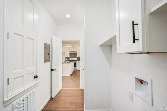 1615 N Guadalupe, Seguin, TX 78155 - washroom featuring wood finished floors, a chandelier, recessed lighting, hookup for a washing machine, and baseboards