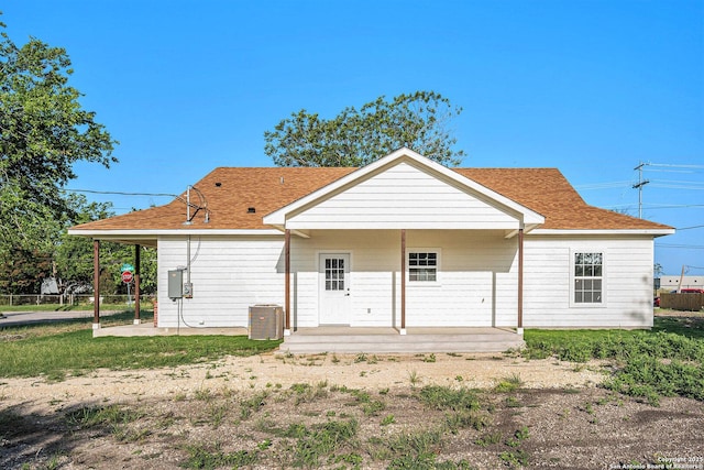 1615 N Guadalupe, Seguin, TX 78155 - rear view of property featuring a shingled roof, central air condition unit, and a patio area