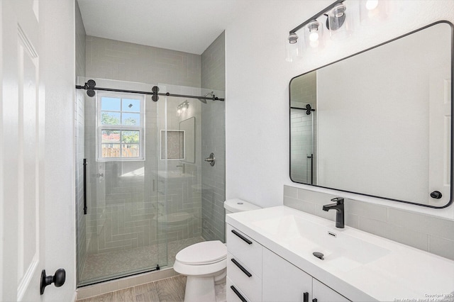 1615 N Guadalupe, Seguin, TX 78155 - full bath featuring toilet, a stall shower, tasteful backsplash, vanity, and wood finished floors