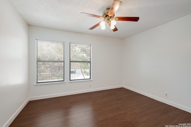 unfurnished room with dark wood-type flooring, a textured ceiling, a ceiling fan, and baseboards