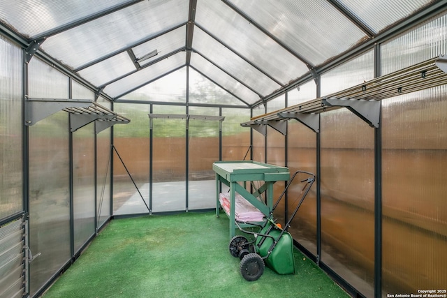 unfurnished sunroom featuring vaulted ceiling
