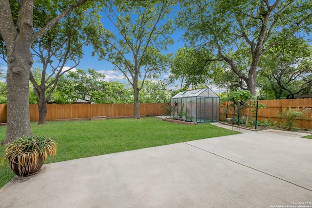 view of yard with an exterior structure, an outbuilding, and a patio