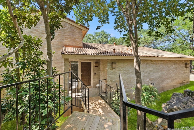 11421 Mission Trce, San Antonio, TX 78230 - view of exterior entry featuring a tile roof and brick siding