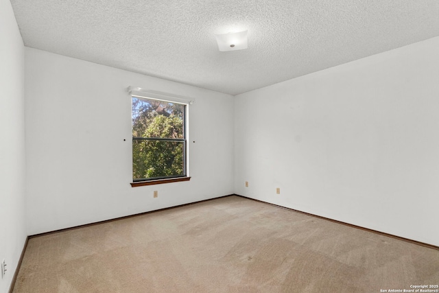 11421 Mission Trce, San Antonio, TX 78230 - carpeted spare room featuring a textured ceiling and baseboards