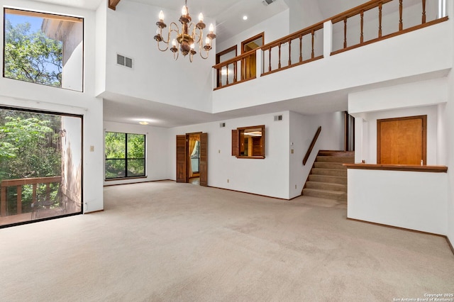 11421 Mission Trce, San Antonio, TX 78230 - unfurnished living room with a towering ceiling, stairway, carpet, a chandelier, and baseboards