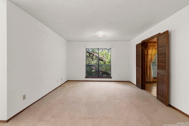 11421 Mission Trce, San Antonio, TX 78230 - empty room featuring carpet floors, a textured ceiling, and baseboards
