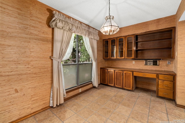 11421 Mission Trce, San Antonio, TX 78230 - unfurnished dining area with wood walls, a chandelier, a desk, and a textured ceiling