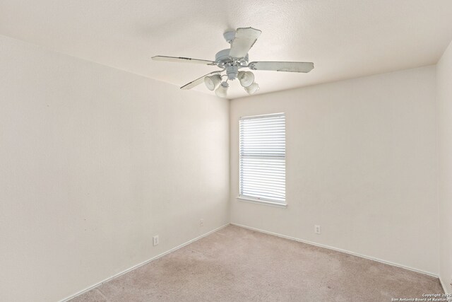 3601 Diamond Fls, Schertz, TX 78154 - empty room featuring light carpet, ceiling fan, and baseboards