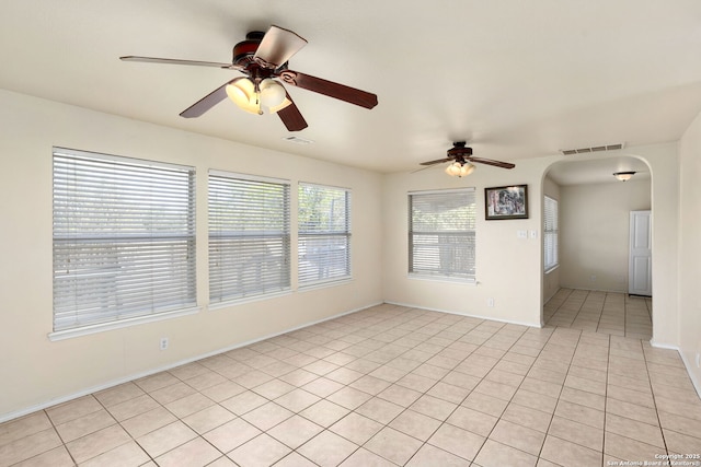 3601 Diamond Fls, Schertz, TX 78154 - unfurnished room featuring ceiling fan, arched walkways, light tile patterned flooring, and baseboards