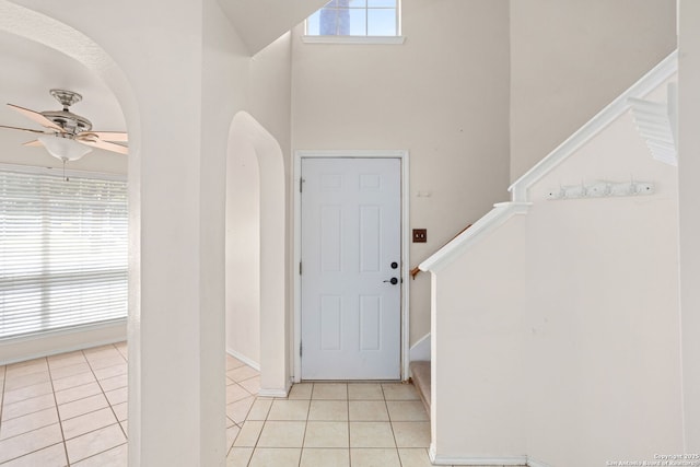 3601 Diamond Fls, Schertz, TX 78154 - foyer entrance featuring a ceiling fan, light tile patterned flooring, stairs, arched walkways, and a high ceiling