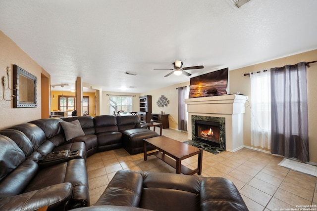 934 Saxonhill, San Antonio, TX 78253 - living area featuring light tile patterned floors, a ceiling fan, and a premium fireplace