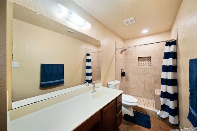 934 Saxonhill, San Antonio, TX 78253 - bathroom featuring toilet, tiled shower, wood finished floors, a textured wall, and vanity
