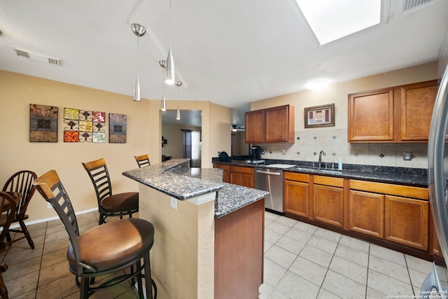 934 Saxonhill, San Antonio, TX 78253 - kitchen featuring stainless steel dishwasher, a sink, a breakfast bar, light tile patterned floors, and tasteful backsplash