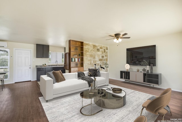 6711 Greencastle, San Antonio, TX 78242 - living area with dark wood finished floors, a ceiling fan, and a wall mounted air conditioner