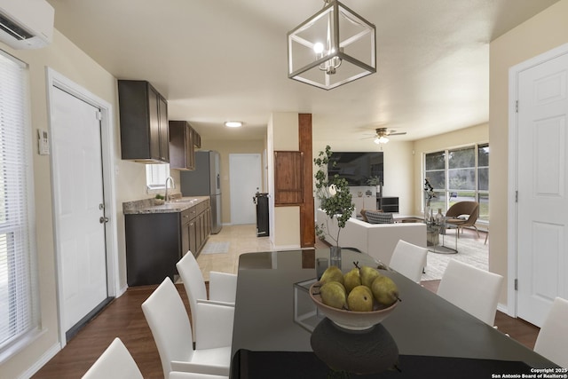6711 Greencastle, San Antonio, TX 78242 - dining area featuring a wall mounted AC, light wood-type flooring, and a ceiling fan