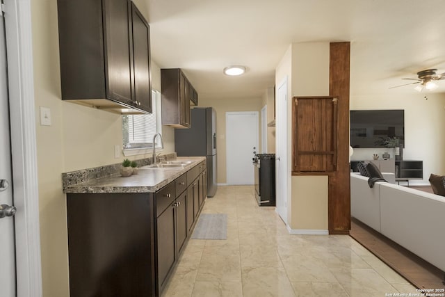 6711 Greencastle, San Antonio, TX 78242 - kitchen featuring a sink, dark brown cabinetry, a ceiling fan, and stainless steel fridge with ice dispenser