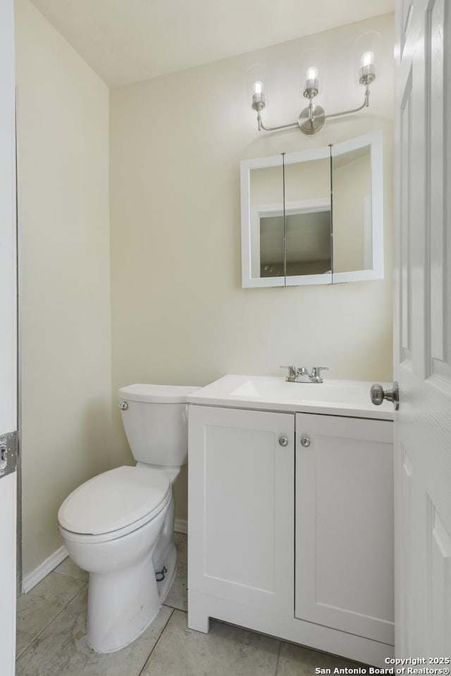 6711 Greencastle, San Antonio, TX 78242 - bathroom featuring vanity, toilet, and baseboards