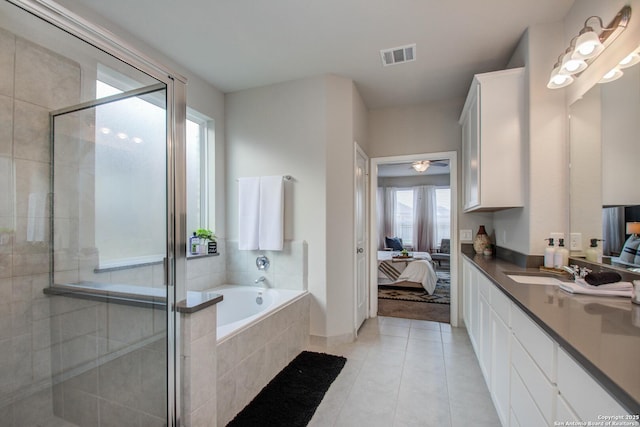 7606 Cottonwood Fls, Spring, TX 77379 - full bath featuring ensuite bathroom, a shower stall, a bath, vanity, and tile patterned floors