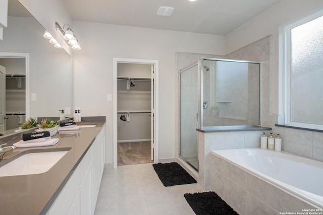 7606 Cottonwood Fls, Spring, TX 77379 - bathroom with tile patterned flooring, a stall shower, a bath, and a walk in closet