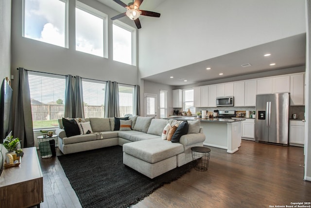 7606 Cottonwood Fls, Spring, TX 77379 - living area featuring a ceiling fan, a towering ceiling, dark wood finished floors, and recessed lighting