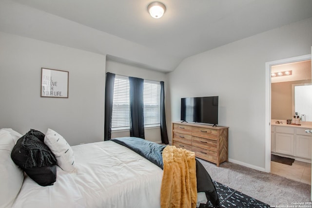 7606 Cottonwood Fls, Spring, TX 77379 - bedroom with lofted ceiling, light colored carpet, connected bathroom, and baseboards