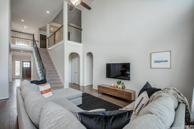 7606 Cottonwood Fls, Spring, TX 77379 - living room featuring a towering ceiling, stairs, wood finished floors, ceiling fan, and recessed lighting