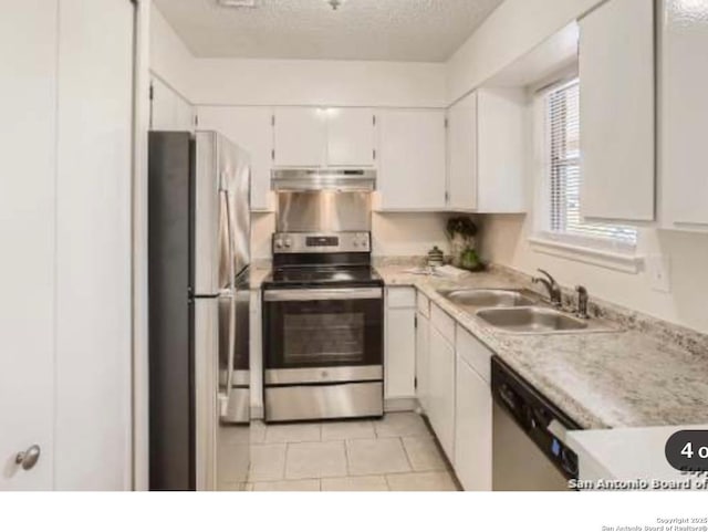923 Vance Jackson Unit 1210, San Antonio, TX 78201 - kitchen featuring appliances with stainless steel finishes, a sink, under cabinet range hood, light countertops, and white cabinetry