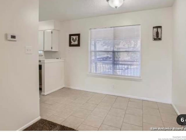 923 Vance Jackson Unit 1210, San Antonio, TX 78201 - unfurnished dining area with baseboards and light tile patterned floors