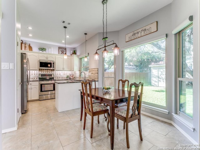 dining area featuring light tile patterned floors, recessed lighting, and baseboards