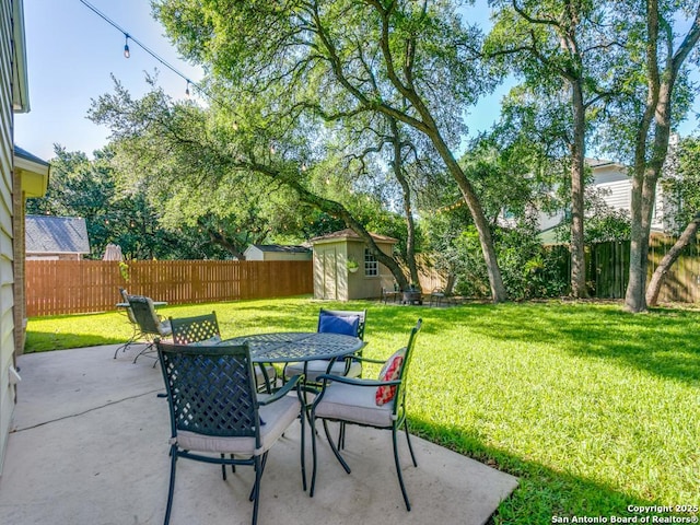 view of patio featuring outdoor dining area, an outdoor structure, and a storage unit
