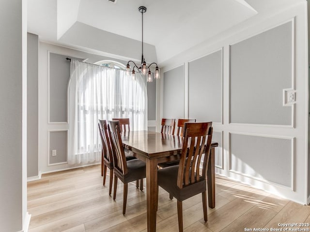 dining space with a chandelier and light wood-style flooring