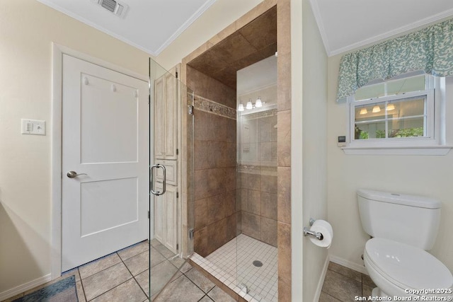 bathroom with ornamental molding, a shower stall, tile patterned floors, baseboards, and toilet
