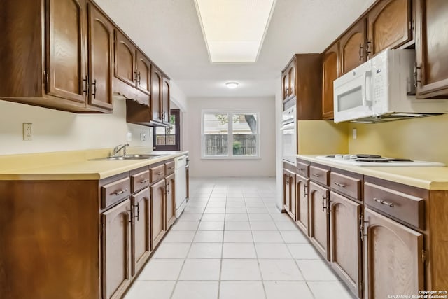 10514 Merritime Ct, San Antonio, TX 78217 - kitchen with a sink, white appliances, light countertops, and light tile patterned flooring