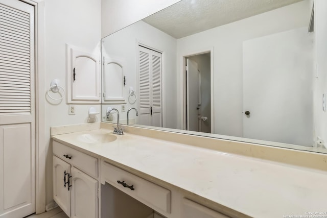 10514 Merritime Ct, San Antonio, TX 78217 - bathroom with vanity and a textured ceiling