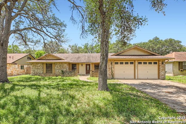 ranch-style home with an attached garage, asphalt driveway, a front yard, and brick siding