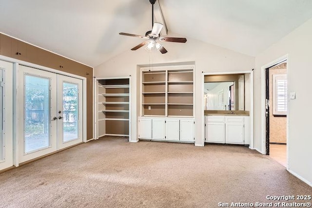 unfurnished living room featuring light colored carpet, french doors, healthy amount of natural light, and a ceiling fan