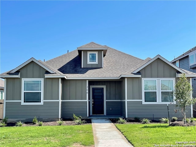 306 Banff, Kyle, TX 78640 - bungalow-style home featuring board and batten siding, a front yard, and a shingled roof