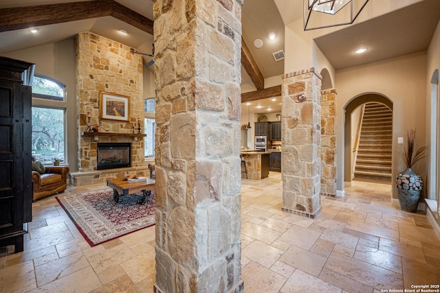 1040 Glenwood, Bulverde, TX 78163 - interior space with stone tile flooring, high vaulted ceiling, a fireplace, ornate columns, and recessed lighting